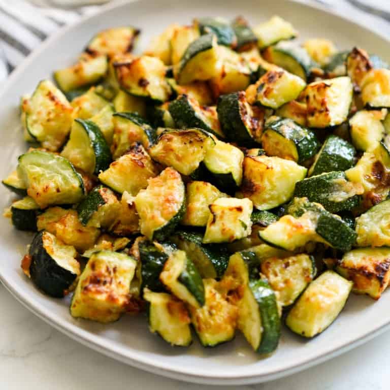 A round plate of diced zucchini that are crispy and golden brown on the outside