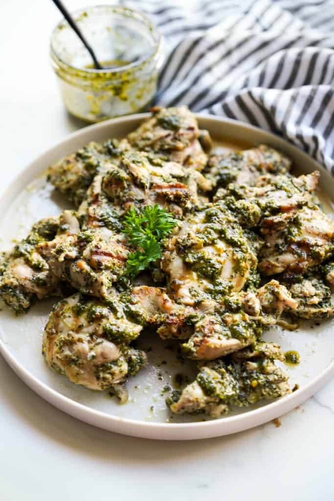 a plate loaded with chimichurri chicken thighs