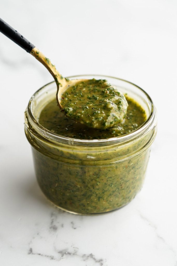 Homemade chimichurri sauce in a jar