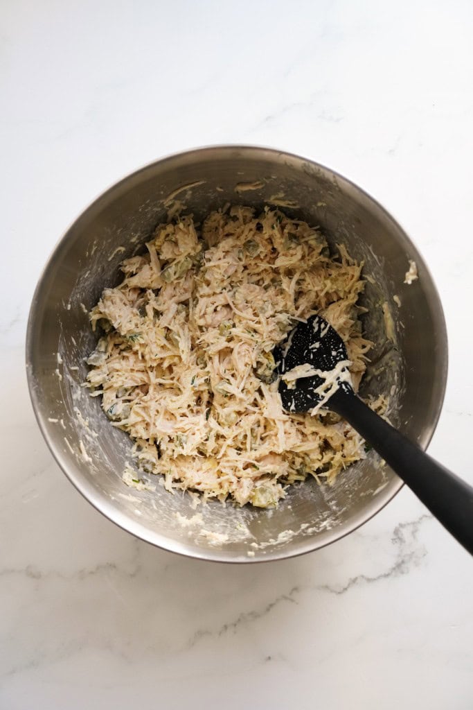 Dill pickle chicken salad in a large mixing bowl