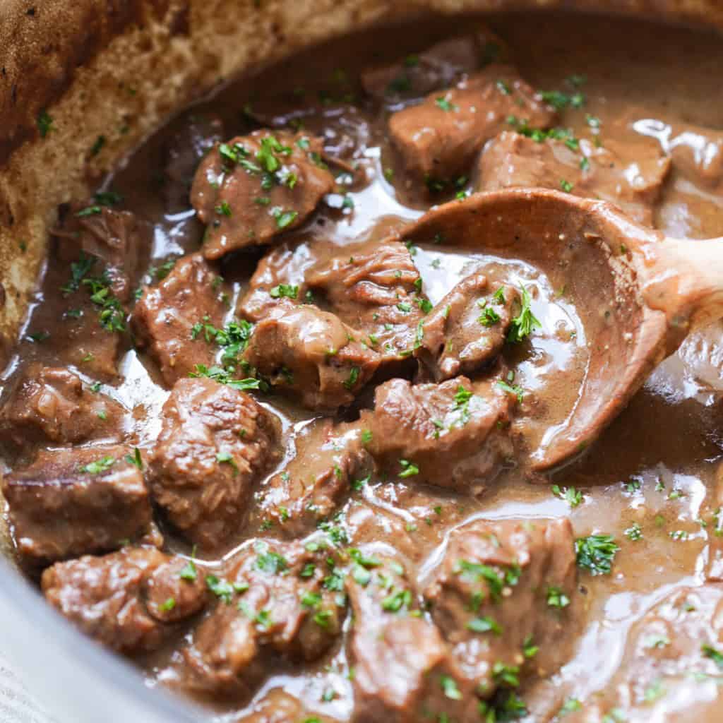 Scooping up chunky beef in thick brown gravy