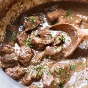 Scooping up chunky beef in thick brown gravy