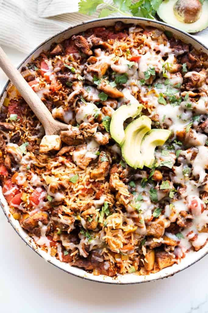 Top down view of a braiser loaded with Mexican chicken and rice