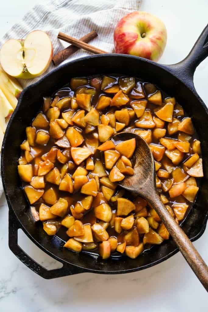 A cast iron skillet loaded with saucy fried apples