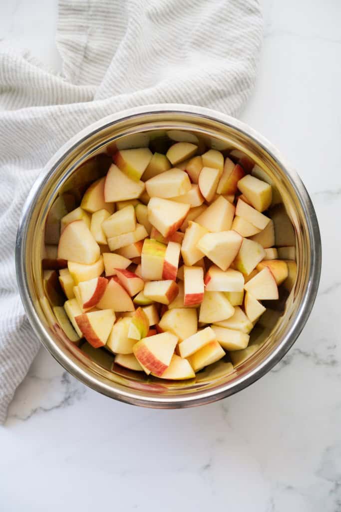 Cubed apples in a mixing bowl