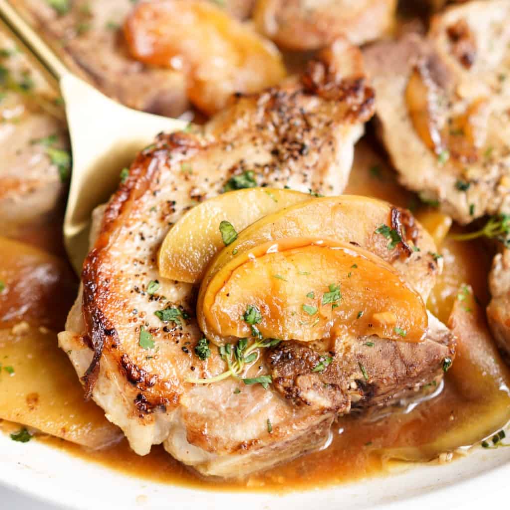 Pork chop topped with cooked sliced apples