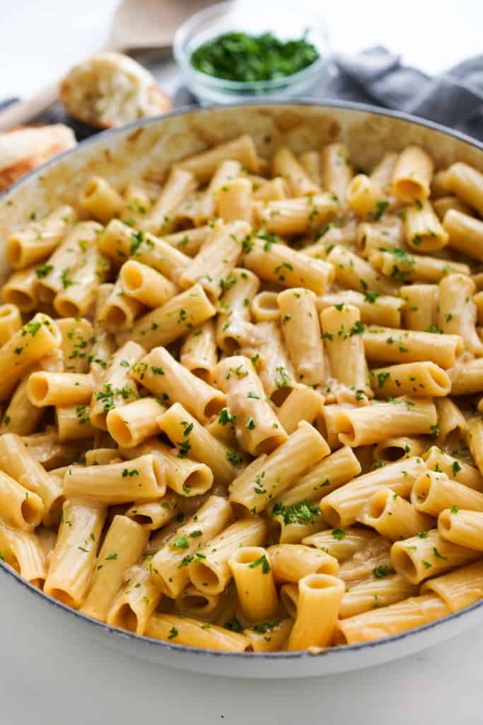 A large skillet loaded with French onion soup pasta