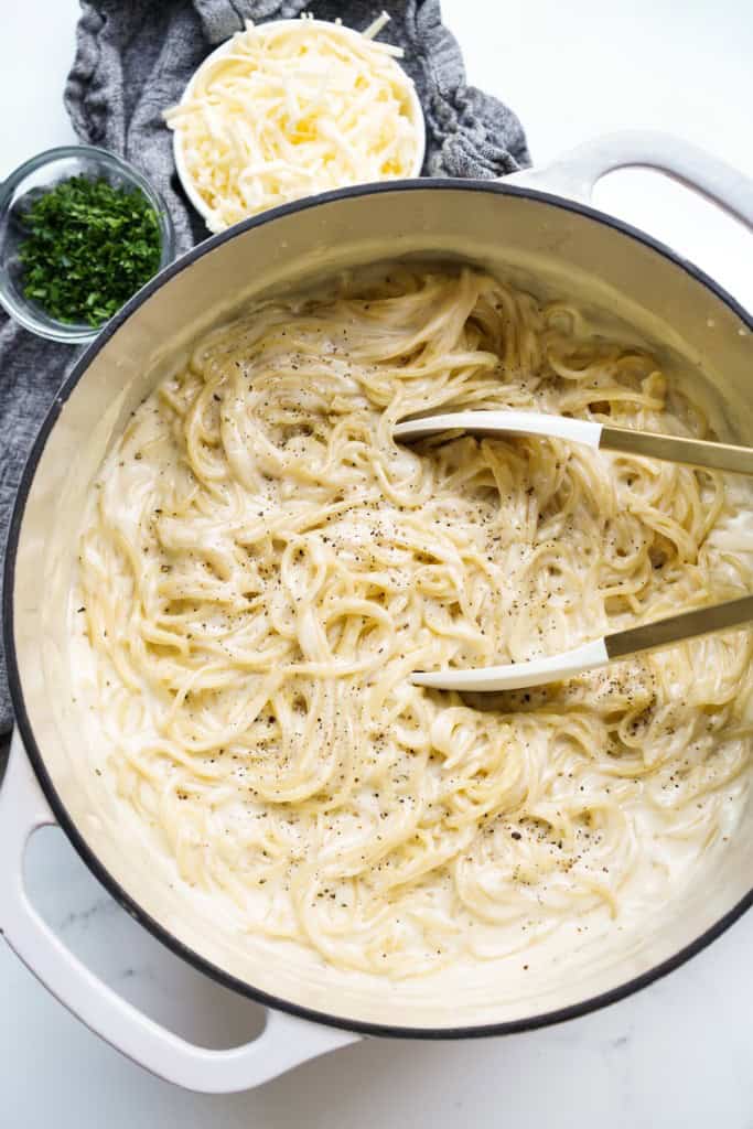 Top down view of a pot of spaghetti in cheese sauce