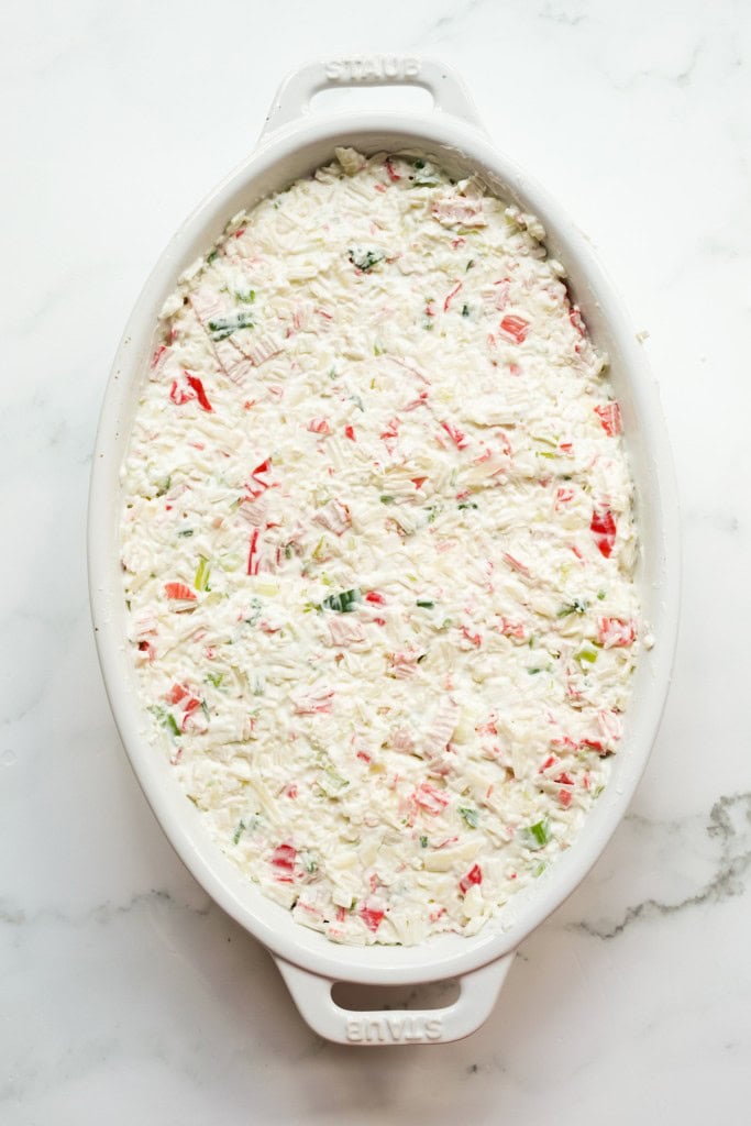 Crab rangoon dip in a casserole dish before baking