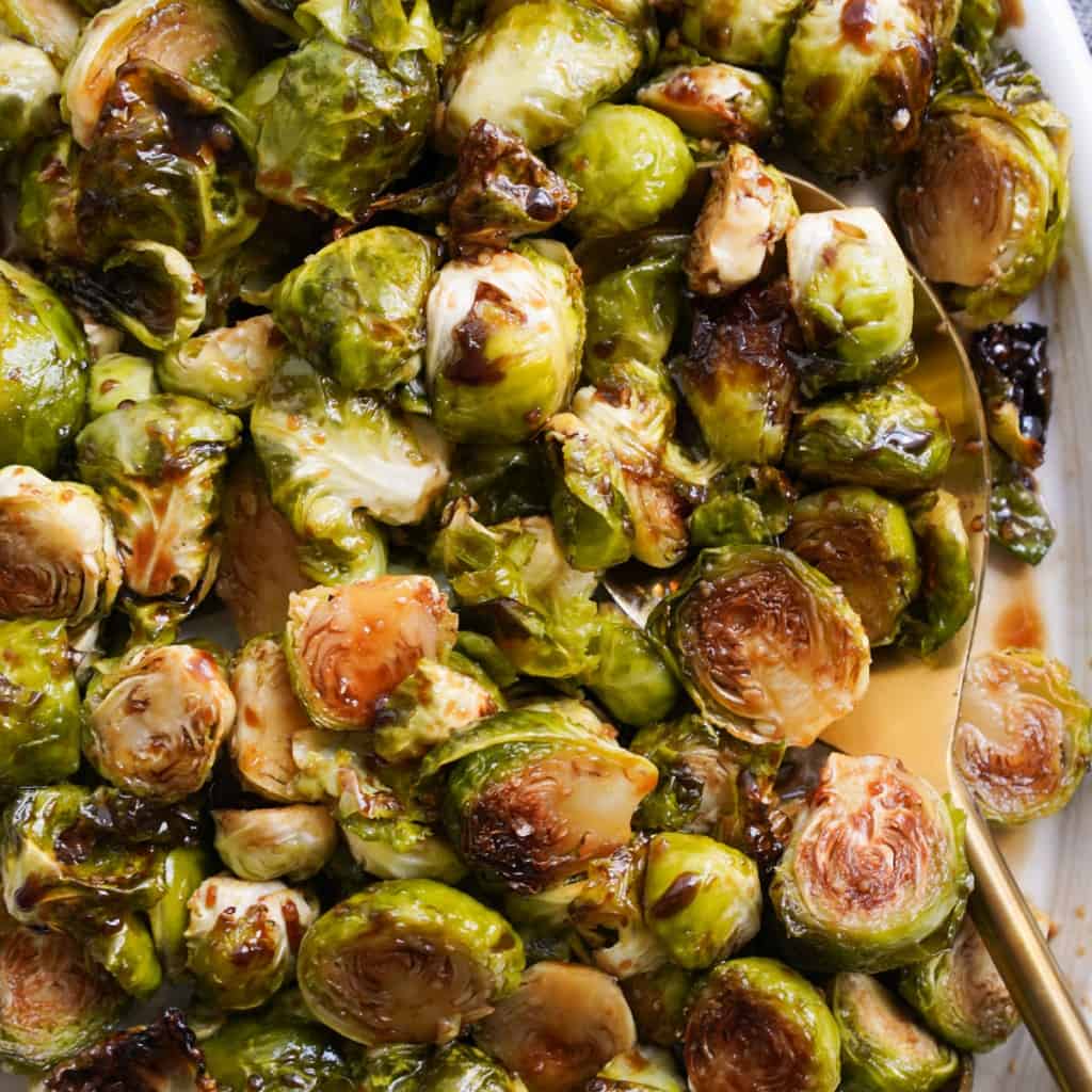 Charred brussels sprouts topped with balsamic glaze