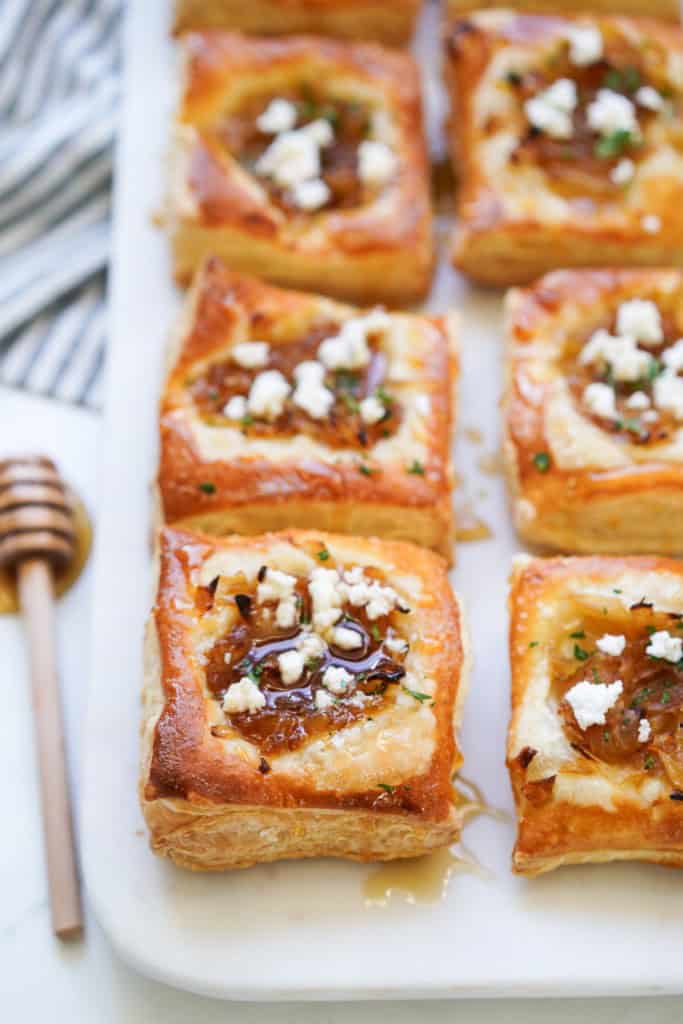 Puff pastry tart topped with caramelized onions and crumbled goat cheese