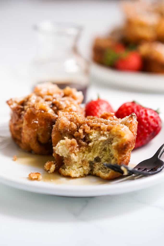 French toast muffins that is cut into with a fork on a plate