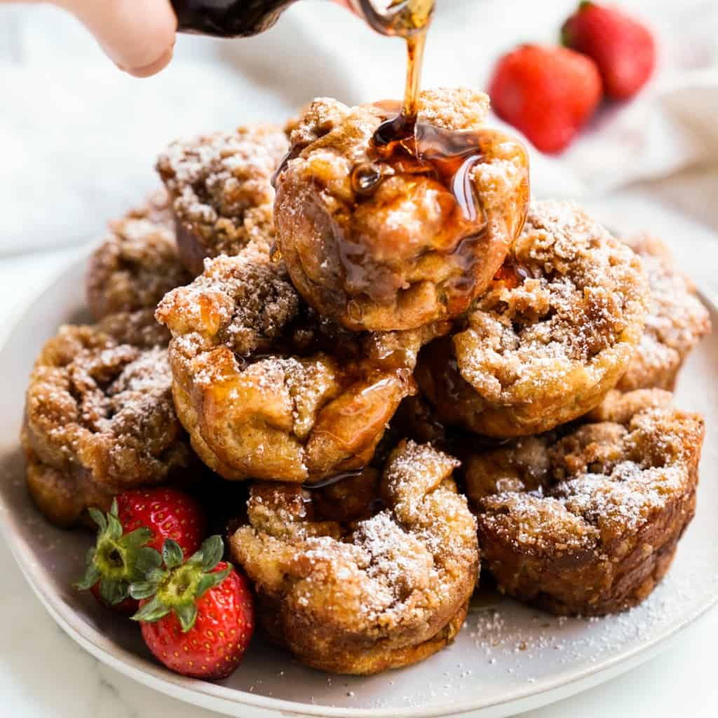 Maple syrup being drizzled onto French toast muffins