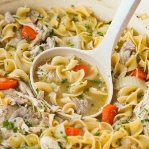 Scooping up warm and cozy chicken noodle soup