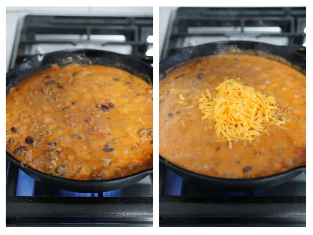 Chili cheese dip cooking on a cast iron skillet, then shredded cheddar cheese is added
