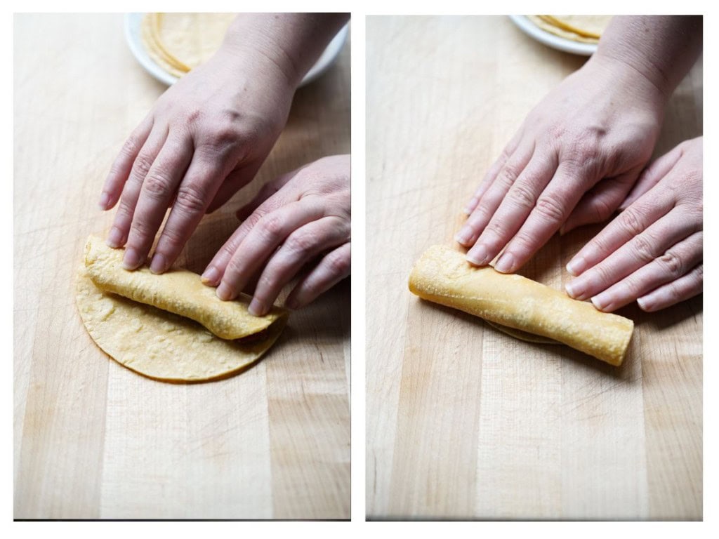 Continue rolling the corn tortilla until it is fully rolled into a taquito.