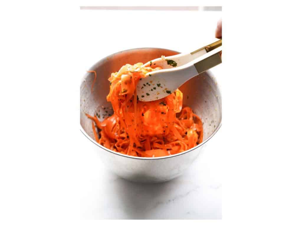 Toss carrot ribbons in sauce with tongs