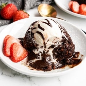 A close up shot of a chocolate lave cake that has been opened up showing its gooey chocolate center.