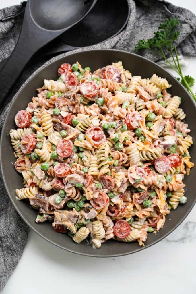 Top down shot of a black bowl filled with Bacon Ranch Pasta Salad.
