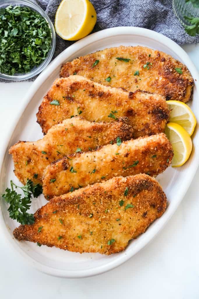 A plate full of crispy breaded chicken cutlets