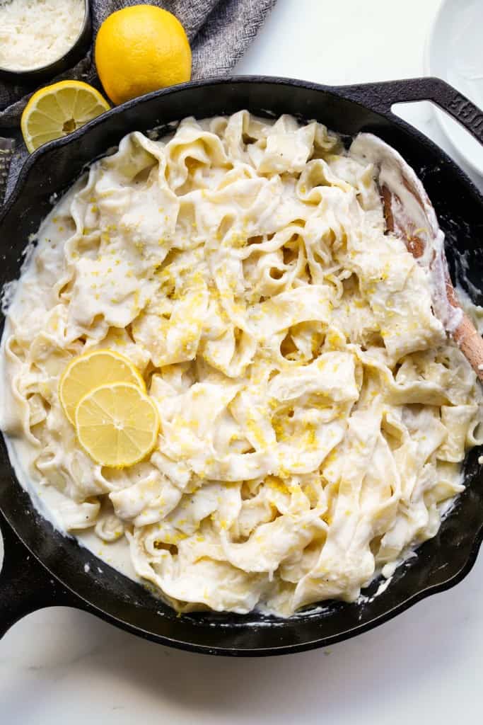 Top down pictures of a cast iron filled with creamy Lemon Ricotta Pasta.