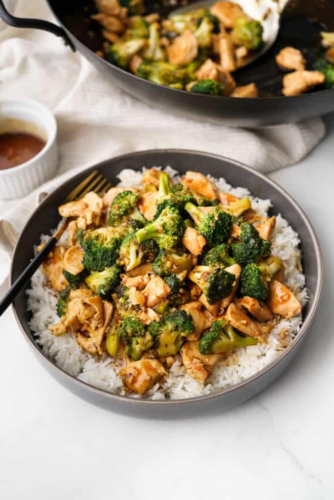 Chinese Chicken and Broccoli is in a bowl on top of white rice.