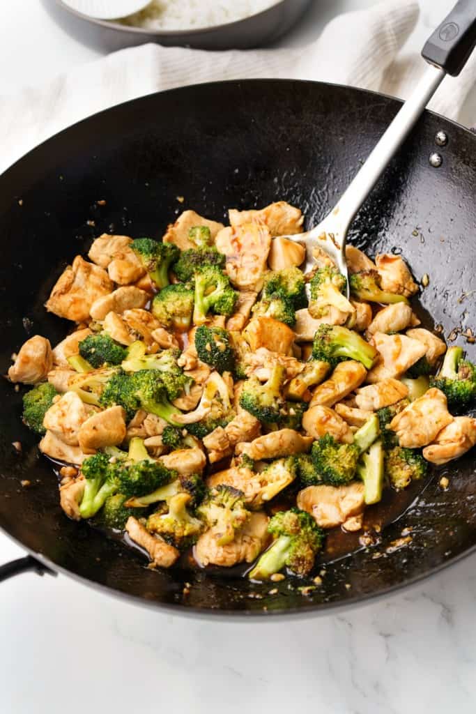 A wok is filled with Broccoli Chicken that just finished cooking.