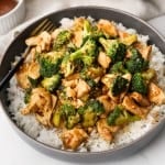 Close up picture of Broccoli Chicken layered over rice in a bowl.