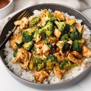 Close up picture of Broccoli Chicken layered over rice in a bowl.