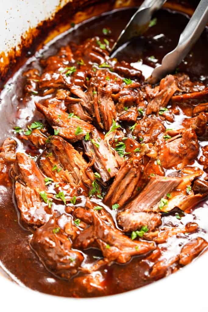 Barbecue pot roast is easily shredded inside the slow cooker.