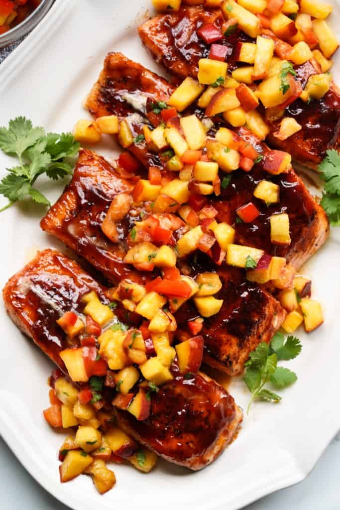 Barbecue salmon filets are topped with fresh peach salsa.