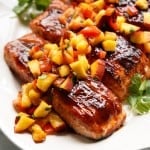 BBQ glazed salmon is topped with a chunky peach salsa.