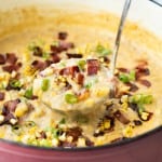 Close up picture of Corn Potato Chowder being scooped out of a large Dutch oven.