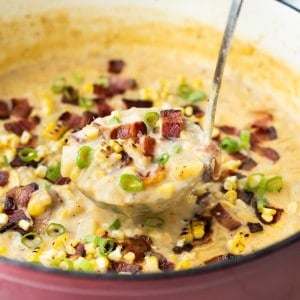 Close up picture of Corn Potato Chowder being scooped out of a large Dutch oven.