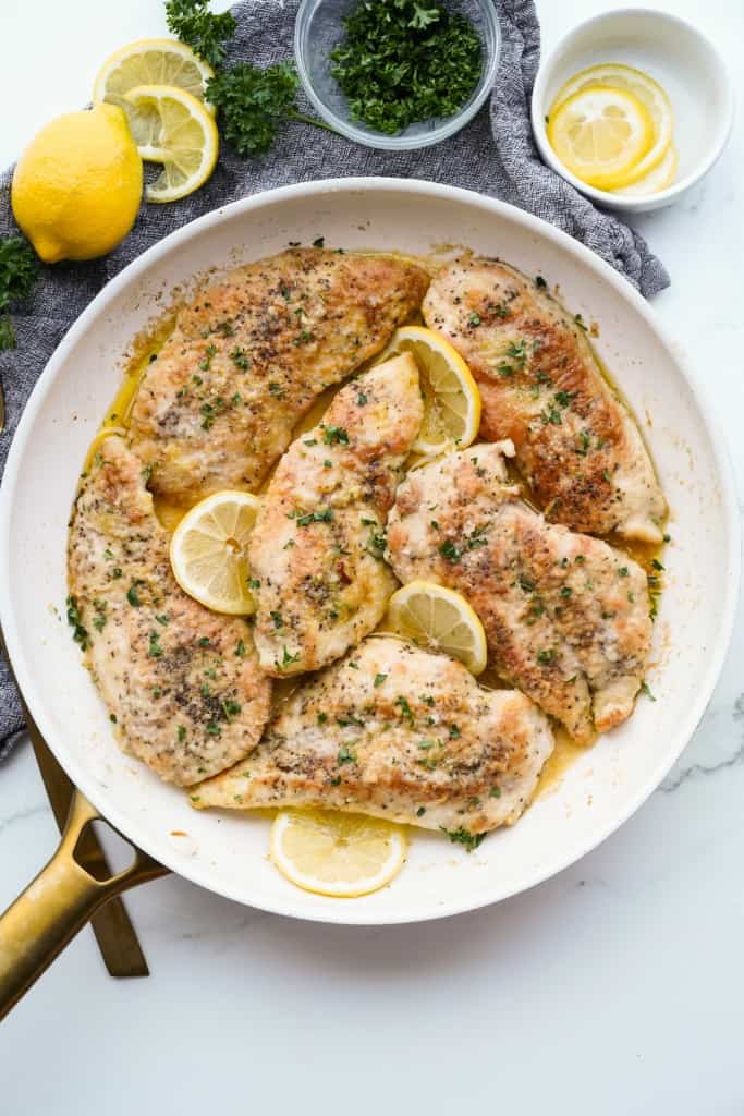 A skillet is filled with freshly cooked Lemon Garlic Butter Chicken.