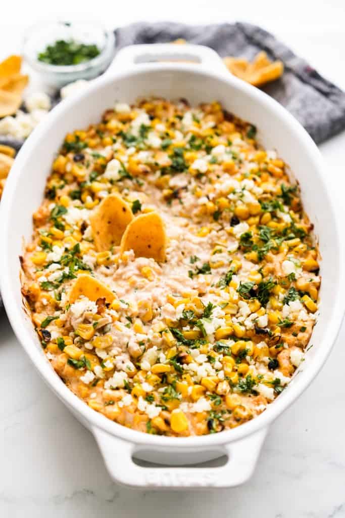 Mexican street corn has been baking in a baking dish and is ready to eat.