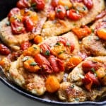 Close up picture of Skillet chicken with blistered tomatoes.