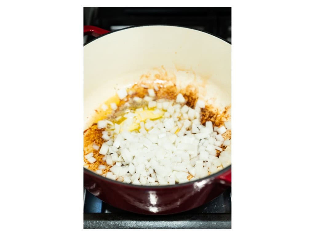 Butter and onions are added to the Dutch oven. Onions are sauted until soft.