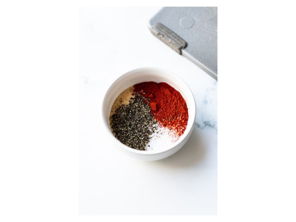 Spices for the corn ribs are mixed in a small bowl.