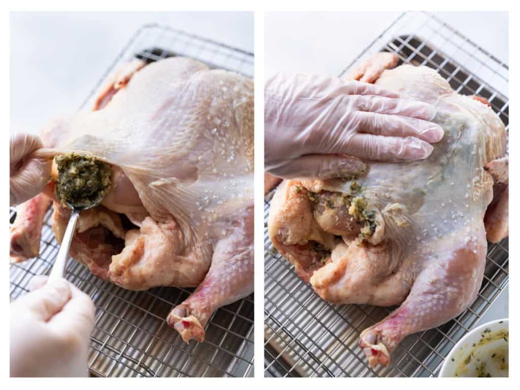Garlic herb butter is placed under the skin of the whole chicken and is spread around.