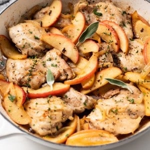 A skillet is filled with Apple Cider Chicken.
