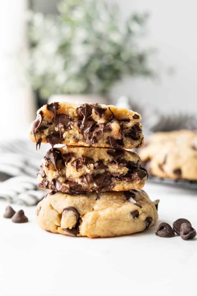 Soft chocolate chips are oozing out of the center a chunky chocolate chip cookie.