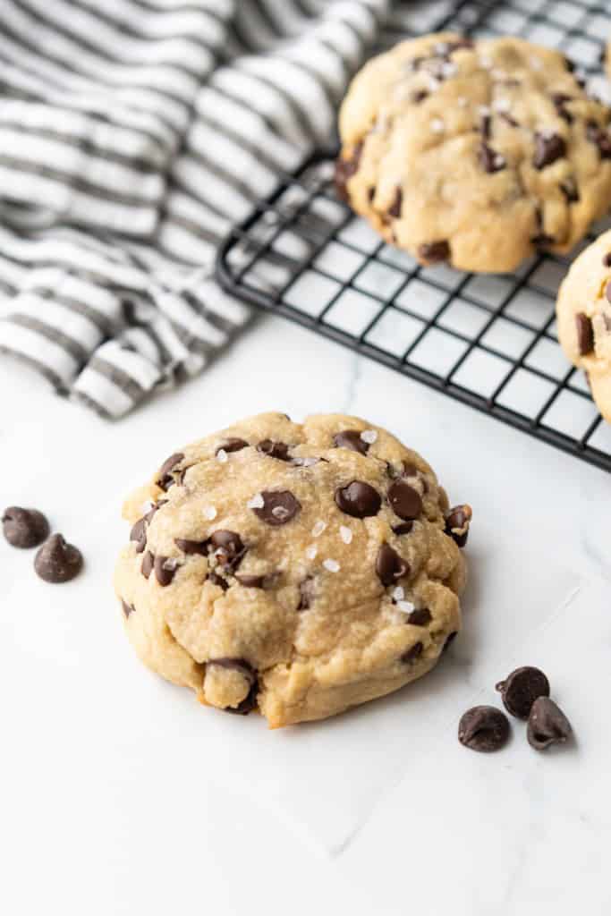 A bakery style chocolate chip cookie is salted and ready to eat.